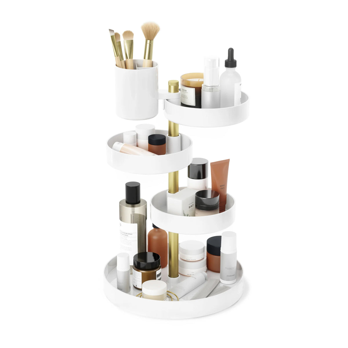 Clear acrylic 360-degree rotating cosmetic organizer on a vanity.